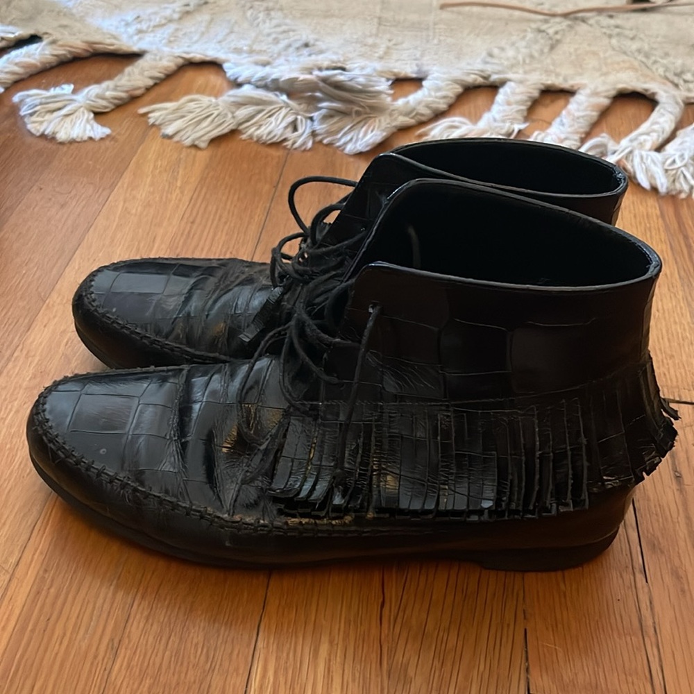 Black snakeskin leather moccasin boots.